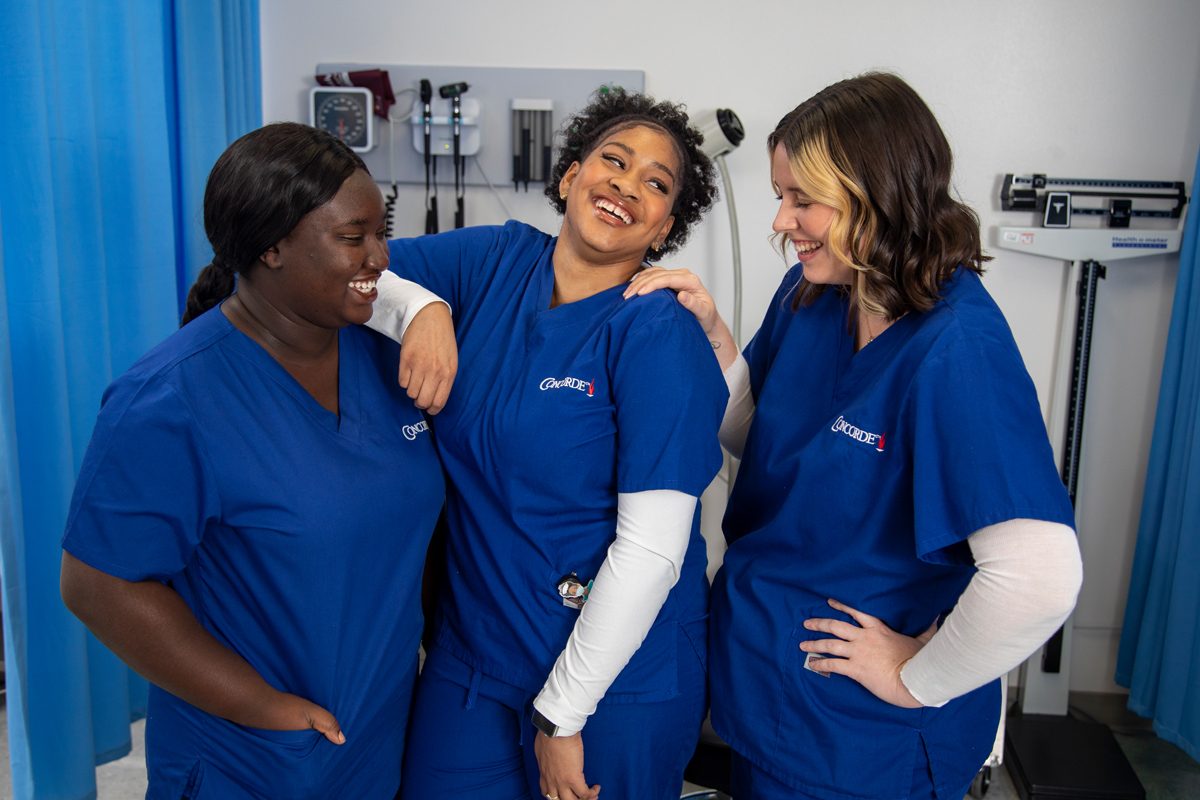 Concorde Career College students in scrubs in a clinical lab